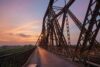 Long Bien old metal bridge at sunset in Hanoi, Vietnam